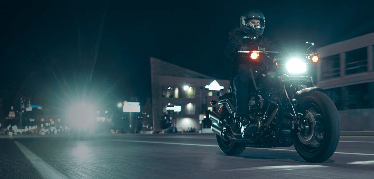 Riding a 2023 Harley-Davidson Cruiser at night on an empty street
